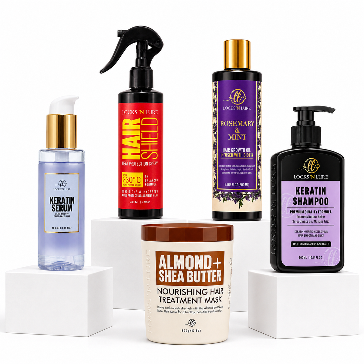 Five Lock 'N Lure haircare products arranged on white display blocks against a white background: a lavender serum bottle, a red hair protection spray bottle, a purple rosemary mint conditioner bottle, a black keratin shampoo bottle, and a brown almond + shea butter treatment mask tub.