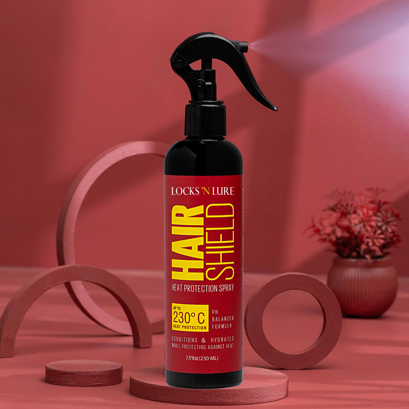 Locks 'N Lure Hair Shield heat protection spray bottle on a red background