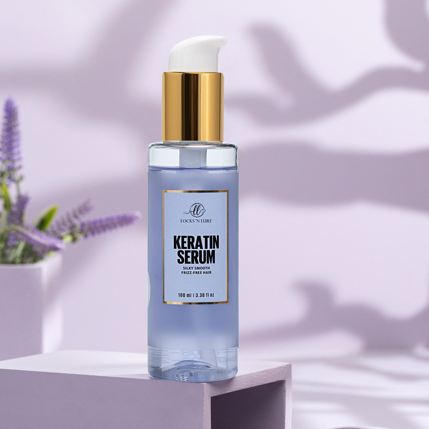 Keratin serum bottle on a light purple background with lavender flowers.