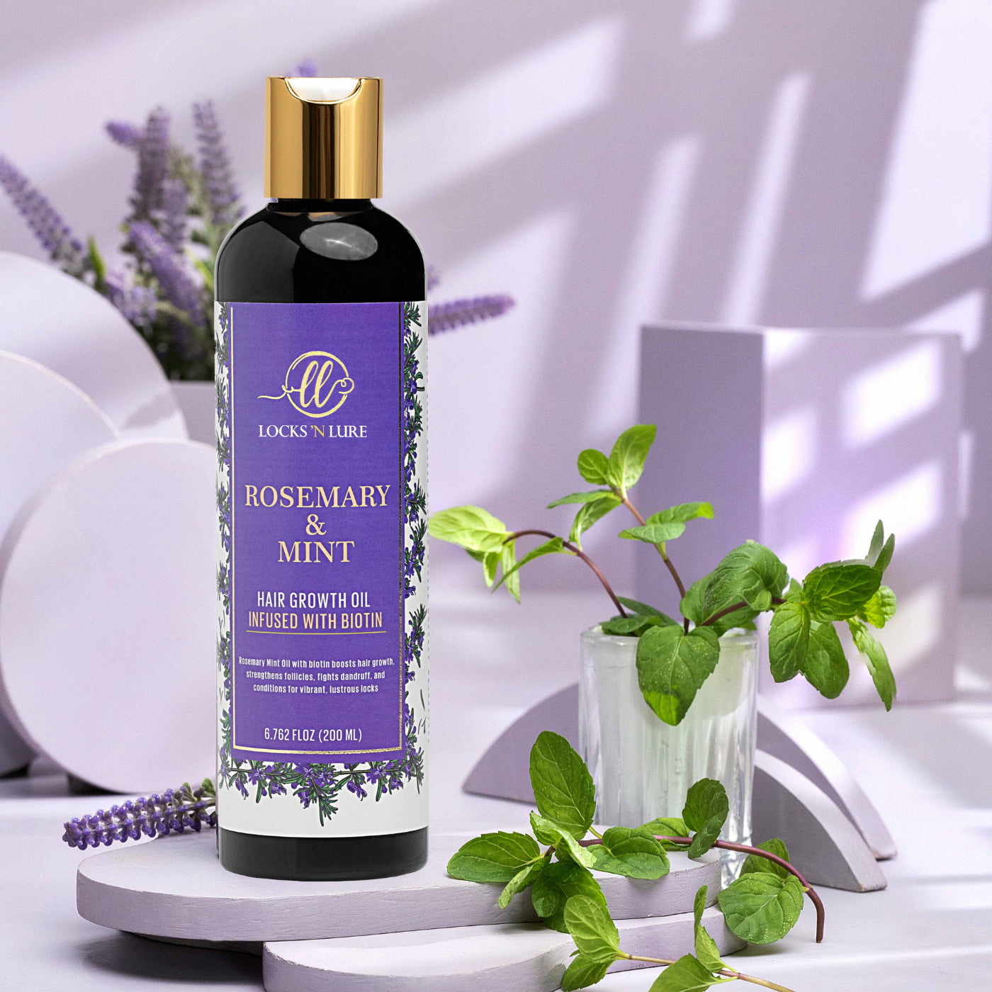 Bottle of Locks 'N Lure Rosemary & Mint hair growth oil with plants on a white background