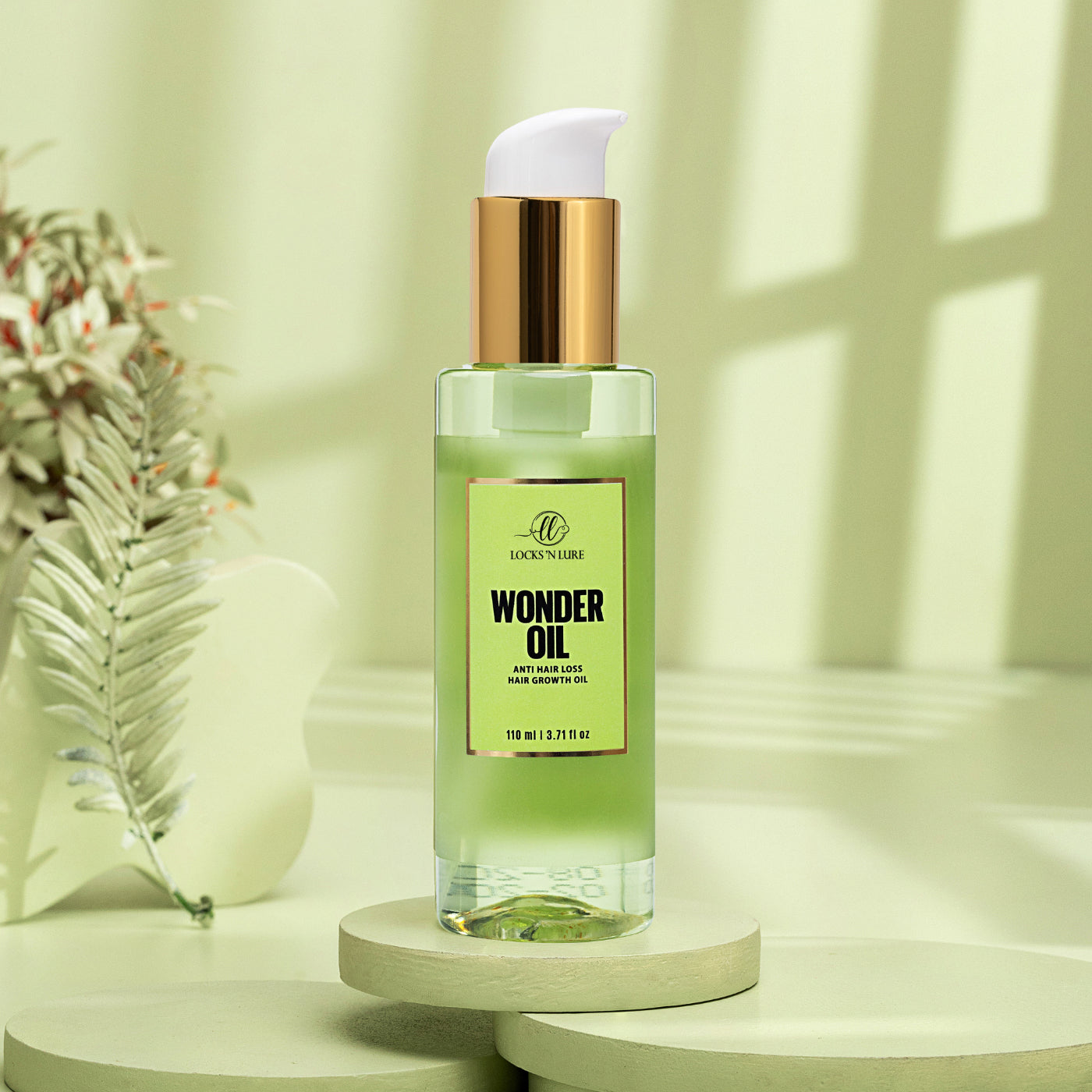 Bottle of wonder oil on a light surface with a plant in the background